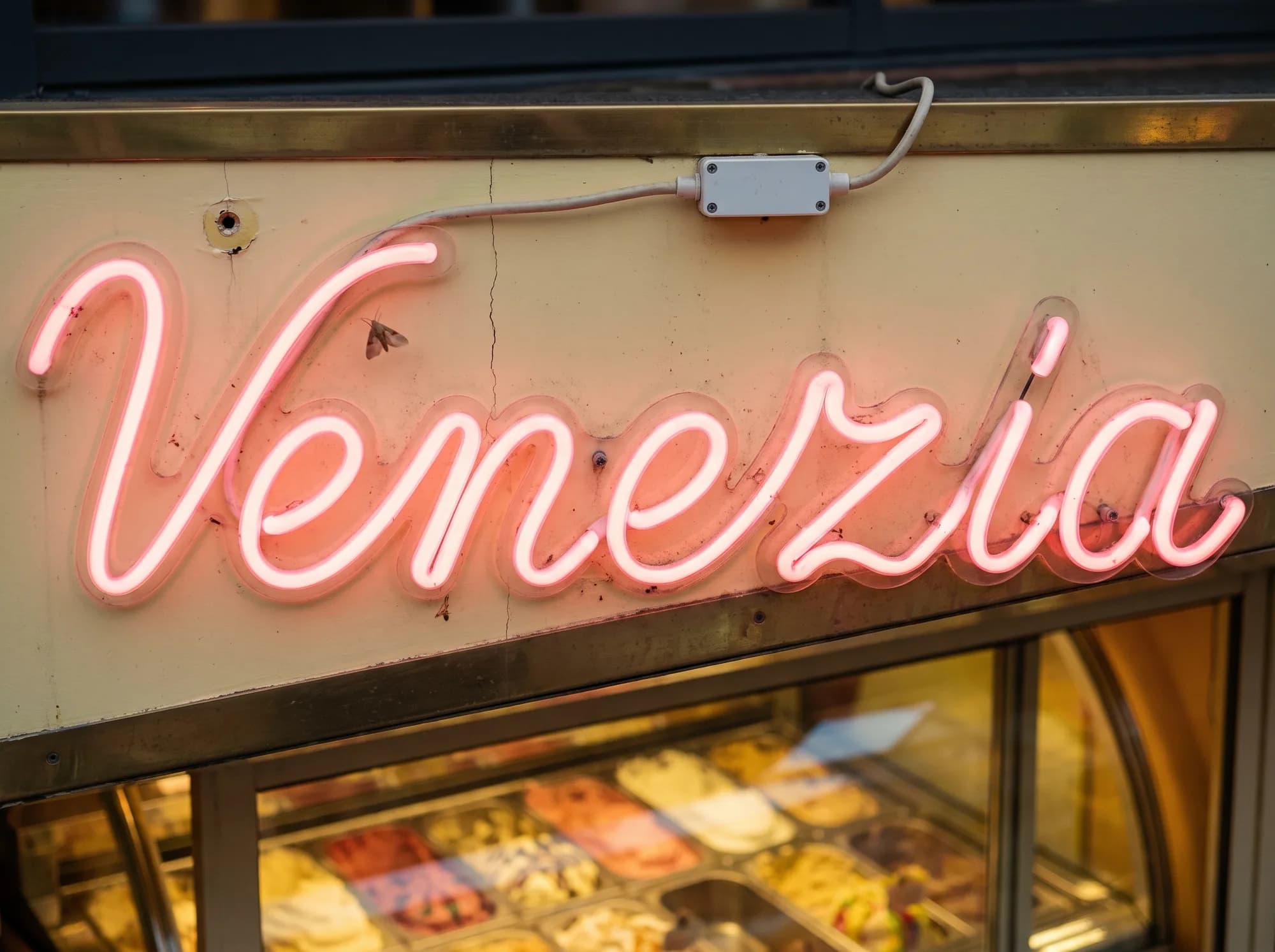 Pink neon script on the cream fascia of an ice cream parlour