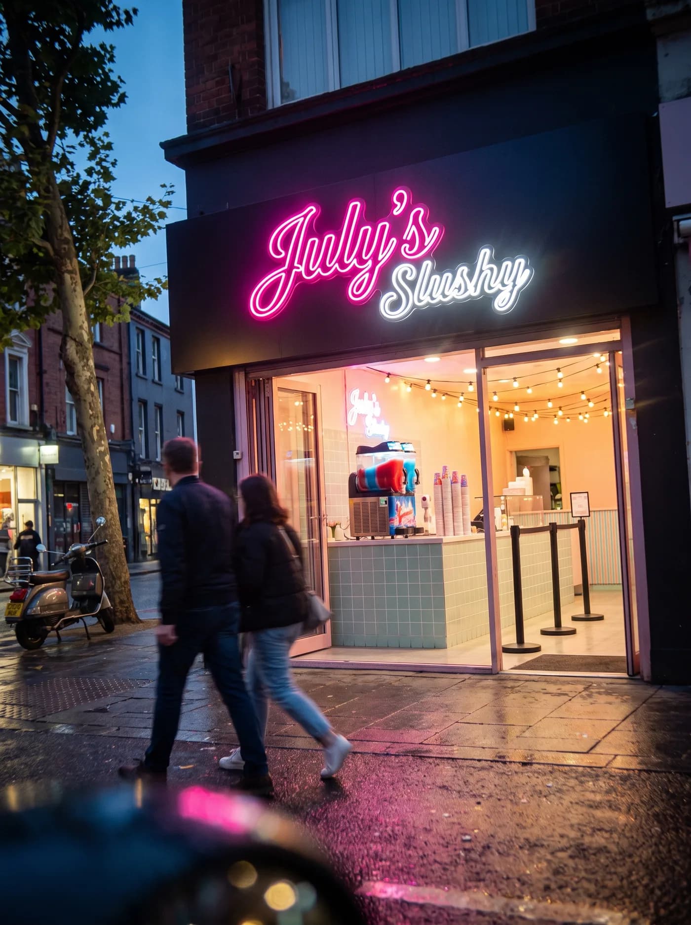 The same slushy shop seen from the street at dusk, the neon sign glowing above the shopfront